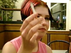 A redhead German girl gets her face sprayed in the public bathroom
